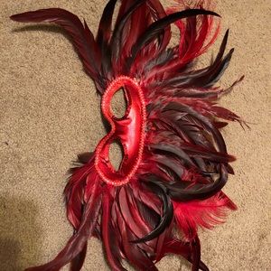 Red and black feathered mask